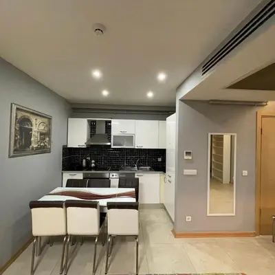 a kitchen and dining room with a table and chairs at Modern Comfort Steps from Taksim in Istanbul