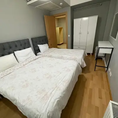 a bedroom with two beds and a desk in it at Modern Comfort Steps from Taksim in Istanbul