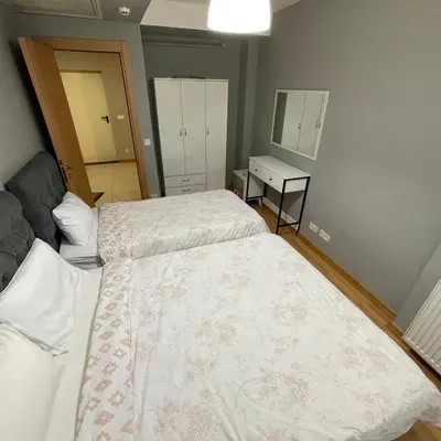 a small bedroom with two beds and a mirror at Modern Comfort Steps from Taksim in Istanbul