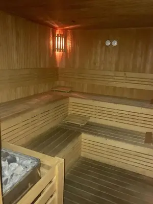 an empty sauna with wooden floors and wooden walls at Bright 2BR Home in Central Istanbul in Istanbul