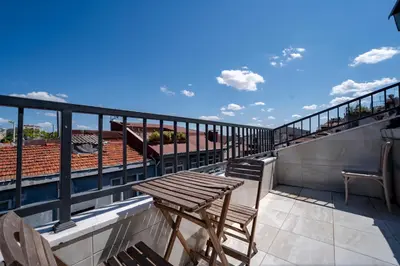 a deck with a wooden table and chairs on a balcony at 3-Bedroom 2-Bathroom Duplex Apartment with Elevator in Istanbul