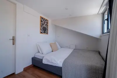 a small bedroom with a bed and a window at 3-Bedroom 2-Bathroom Duplex Apartment with Elevator in Istanbul