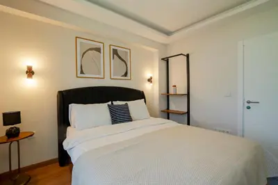 a bedroom with a large bed with a black headboard at 3-Bedroom 2-Bathroom Duplex Apartment with Elevator in Istanbul