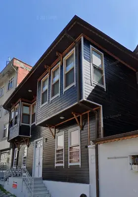a black house with a white garage in front of it at Sweet Home Kadikoy in Istanbul