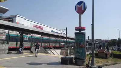 a train station with a man standing in front of a train at Sweet Home Kadikoy in Istanbul