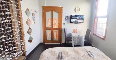 a room with a bed and a table and a door at Sweet Home Kadikoy in Istanbul