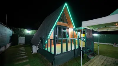 a house with a green light on the roof at night at Hilltop Bungalov Sapanca 3 in Sapanca