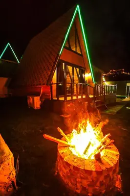 a fire pit in front of a house at night at Hilltop Bungalov Sapanca 3 in Sapanca