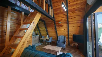 a living room with a staircase in a house at Hilltop Bungalov Sapanca 3 in Sapanca