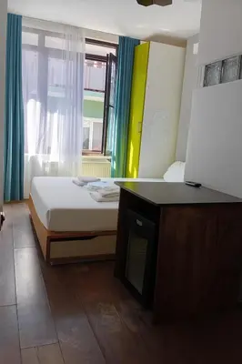 a small bedroom with a bed and a window at As Pansiyon in Istanbul