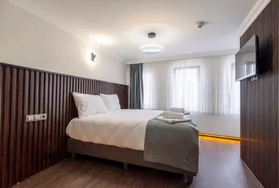 a bedroom with a bed and a flat screen tv at Nine Rooms by taksim in Istanbul