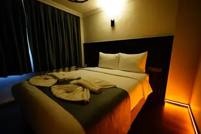a hotel room with a bed with towels on it at Kuyu Apartments near taksim in Istanbul