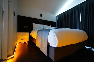 a bedroom with a white bed and a night stand at Kuyu Apartments near taksim in Istanbul