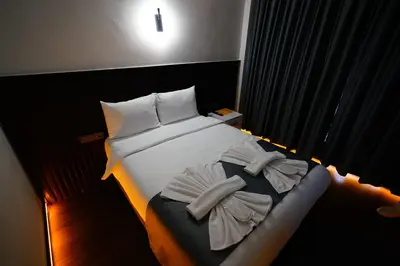 a bed in a hotel room with two towels on it at Kuyu Apartments near taksim in Istanbul