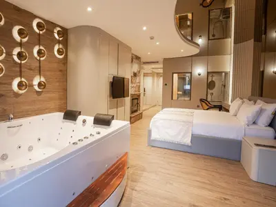 a bedroom with a large bed and a tub at Verona Ağva in Sile