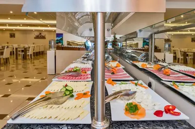 a buffet line with plates of food in a restaurant at Harmony Hotel Merter & SPA in Istanbul
