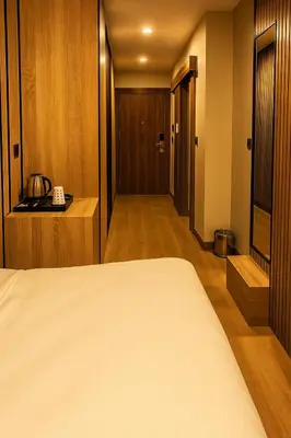a hotel room with a bed and a hallway at Positive Hotel in Arnavutköy