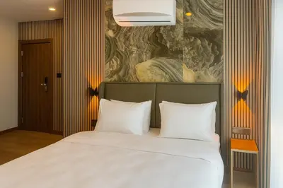 a bedroom with a bed with two white pillows at Positive Hotel in Arnavutköy