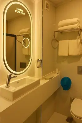 a bathroom with a sink and a mirror at Positive Hotel in Arnavutköy