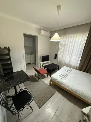 a small room with a bed and a table and chairs at Şişli Suites - Room21 in Istanbul
