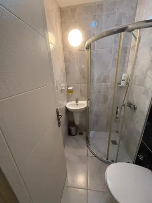 a bathroom with a shower and a toilet and a sink at Şişli Suites - Room21 in Istanbul