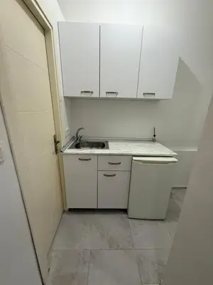 a small kitchen with white cabinets and a sink at Şişli Suites - Room21 in Istanbul