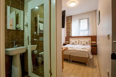 a bedroom with a bed and a sink and a mirror at Pera Sultan Suit in Istanbul