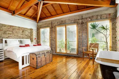 a bedroom with a bed and a brick wall at Alaattin Apartments in Istanbul