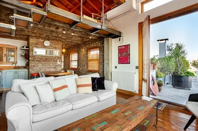 a living room with a white couch and a table at Alaattin Apartments in Istanbul
