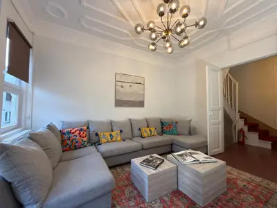 a living room with a couch and a chandelier at Bosphorus Villa Arnavutköy 5BR for 12 Guests in Istanbul