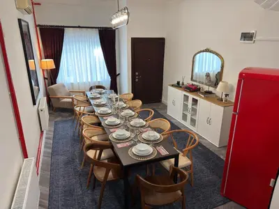 a long table with chairs and a red refrigerator at Bosphorus Villa Arnavutköy 5BR for 12 Guests in Istanbul
