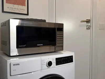 a microwave sitting on top of a washing machine at Bosphorus Villa Arnavutköy 5BR for 12 Guests in Istanbul