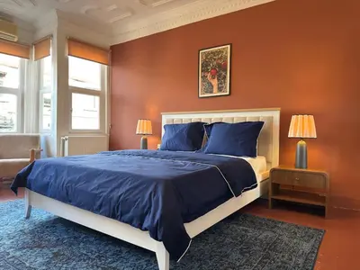 a bedroom with a large bed with blue pillows at Bosphorus Villa Arnavutköy 5BR for 12 Guests in Istanbul