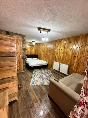 a living room with two beds and a couch at Aytepepark Turistik tesisleri