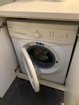 a washing machine with its door open in a kitchen at Taksim'de 2 yatak odalı daire, güvenlik, havuz, spa, otopark in Istanbul
