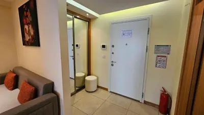 a bathroom with a door leading to a toilet at Taksim'de 2 yatak odalı daire, güvenlik, havuz, spa, otopark in Istanbul
