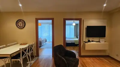 a living room with a dining table and a television at Taksim'de 2 yatak odalı daire, güvenlik, havuz, spa, otopark in Istanbul