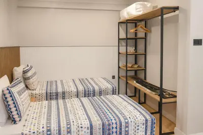 a bedroom with two beds and a shelf at Sare Apartments - Sultanahmet in Istanbul