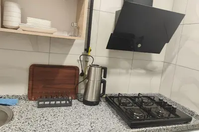 a kitchen counter with a coffee maker and a stove at Sare Apartments - Sultanahmet in Istanbul