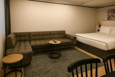 a hotel room with a couch and a bed at Sare Apartments - Sultanahmet in Istanbul