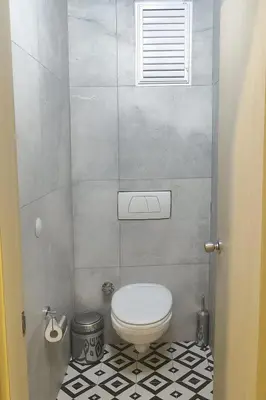 a bathroom with a toilet and a tiled floor at Sare Apartments - Sultanahmet in Istanbul