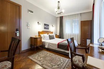 a hotel room with a bed and a table and chairs at Queen Seagull Boutique Hotel in Istanbul