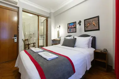 a bedroom with a large bed with a tray on it at Queen Seagull Boutique Hotel in Istanbul