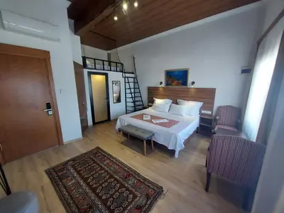 a bedroom with a bed and a door and a rug at Queen Seagull Boutique Hotel in Istanbul