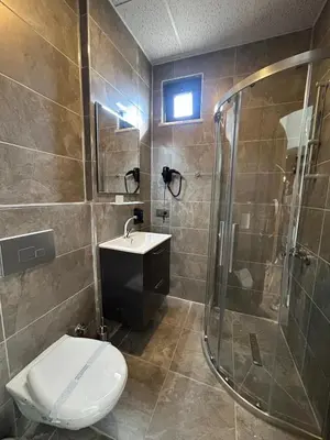 a bathroom with a shower and a toilet and a sink at Rota Business Hotel Gebze in Güzeltepe