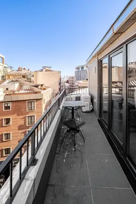 a table on a balcony with a view of a city at B Polat in Istanbul