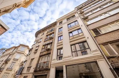 a tall white building with windows on the side of it at B Polat in Istanbul