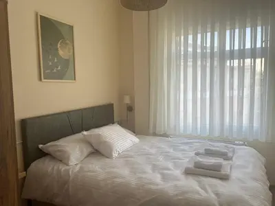 a bedroom with a bed with two towels on it at Karakaş Homes in Istanbul