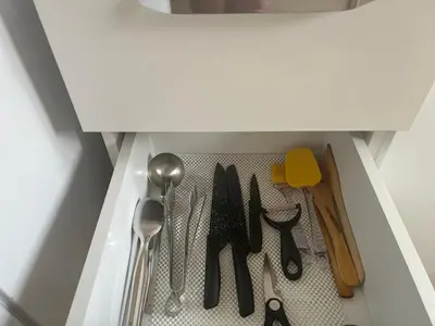 a drawer filled with utensils in a cabinet at Karakaş Homes in Istanbul