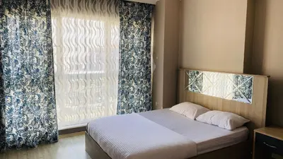 a bedroom with a bed and a large window at Ay suit in Esenyurt
